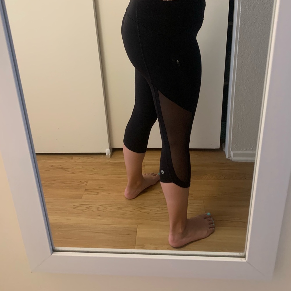 Black Lululemon crop leggings with mesh detail on sides